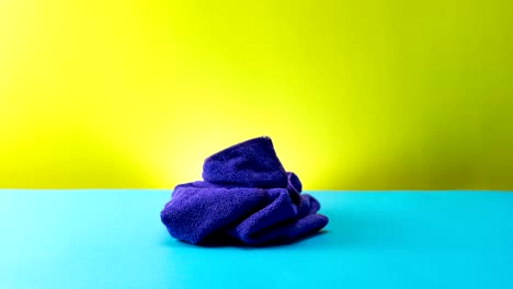 stop motion animation of pile clothes on blue table seamless loop video time lapse