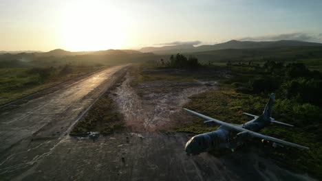 backwards aerial reveal crashed, abandoned military cargo plane (c-105 amazonas) at yanomami´s surucucu airport in roraima, brazil, during the beginnings of the emergency relief efforts in march 2023