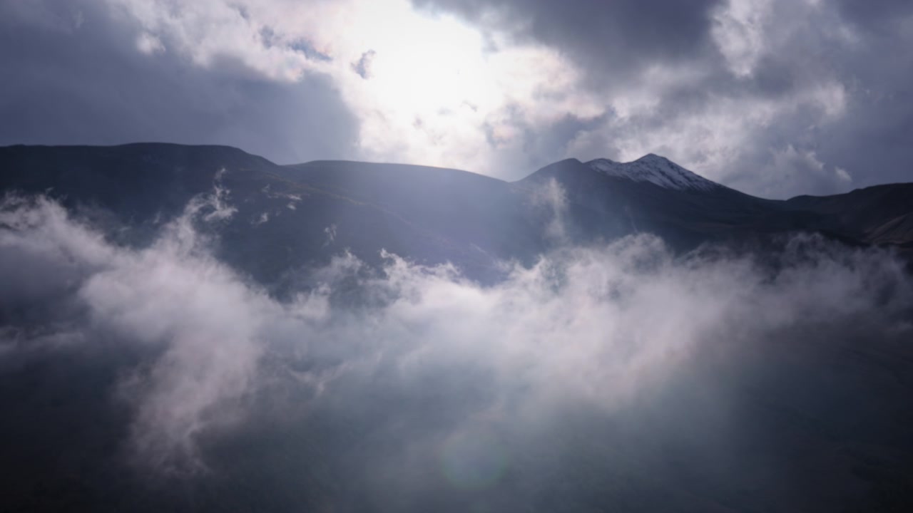 Clouds moving in front of hills