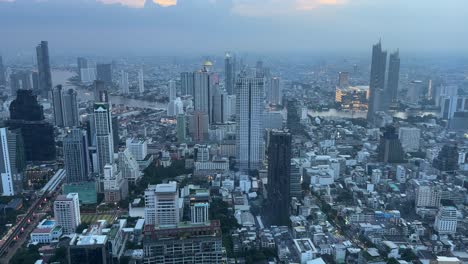 aerial bangkok city thailand. chao phraya river amongst skyscrapers twilight metropolis. buildings over financial business district downtown.
