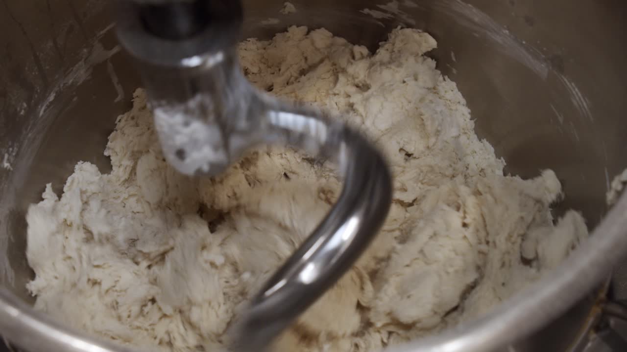 Kneading the pizza dough in big kitchen mixer