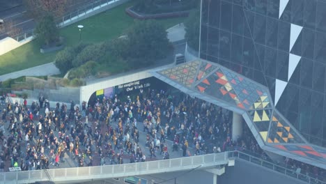 large crowd gathering in melbourne public square