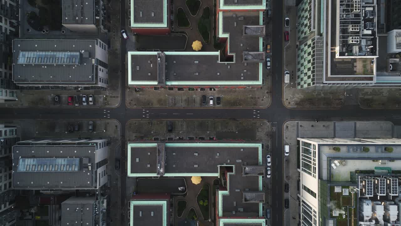 A zoom-out symmetrical top-down aerial view of Dublin's intersection surrounded by contemporary apartment and office buildings. - Docklands, Dublin - Ireland