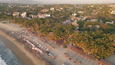 Aerial-of-La-punta-in-Zicatela-beach-Puerto-Escondido-Mexico-Oaxaca-coastline-surf-spot-travel-destination-at-sunset