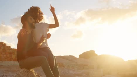 couple sitting together on the beach 4k