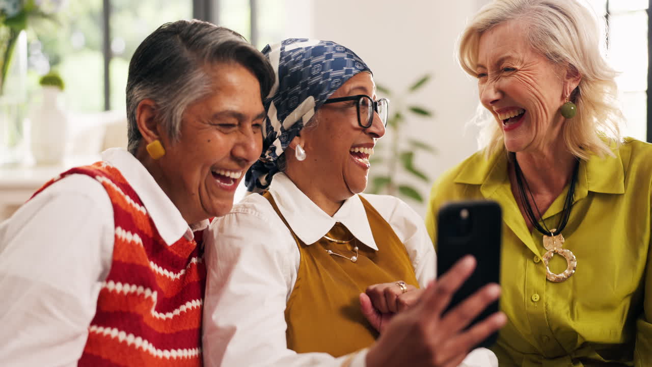 Older women laughing while using a cell phone