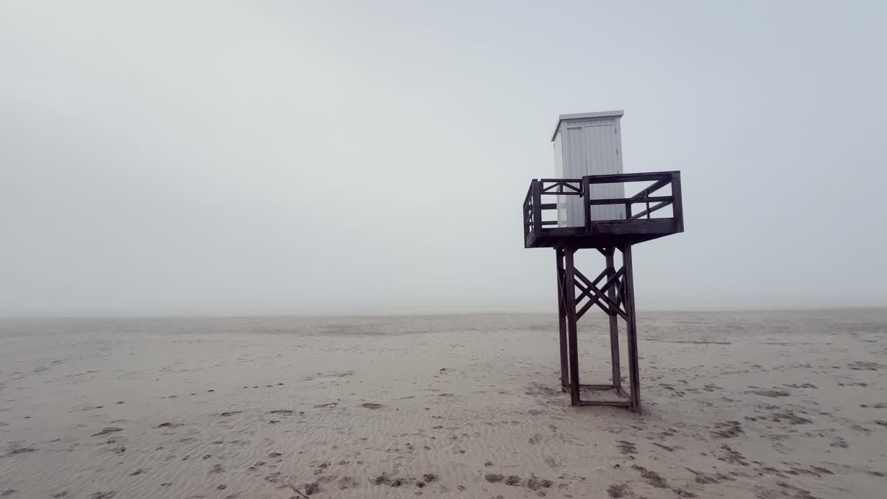 Shot of a lifeguard tower against the backdrop of fog