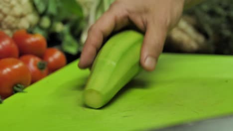 Removing-avocado-pit-with-sharp-knife-from-fresh-fruit,-close-up