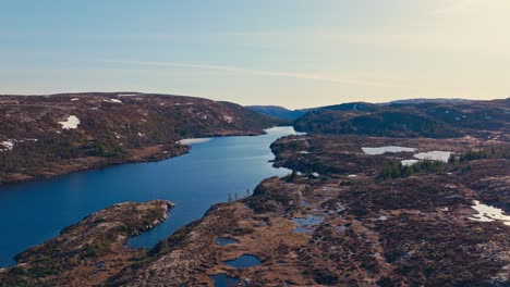 reinsjoen lake with rugged terrain mountains near afjord in norway. aerial drone shot