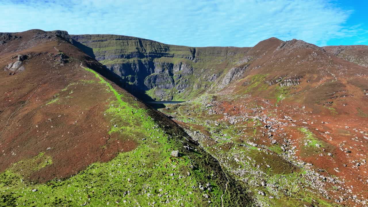 Epic Irish mountain scenery drone pull away of Coumshingaun Lake glacial lake high in The Comeragh Mountains Waterford Ireland