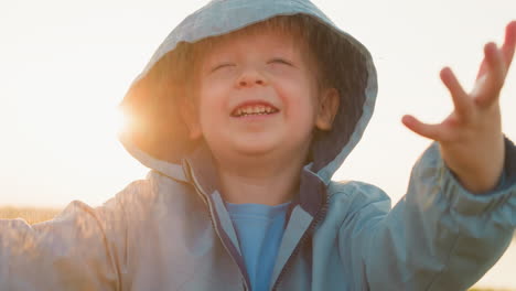 kid finds joy in downpour against sunshine happy boy plays in refreshing rainfall with innocence