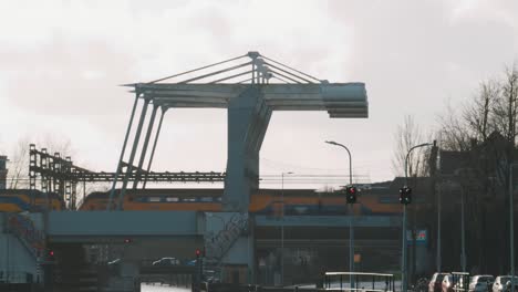 dutch ns train passes special bridge in amsterdam, netherlands