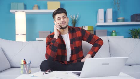 Friendly-and-in-love-young-man-chatting-on-the-phone-with-his-girlfriend.