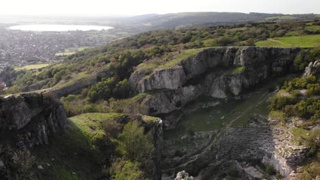 aerial over adult male standing at edge of cliff at cheddar gorge