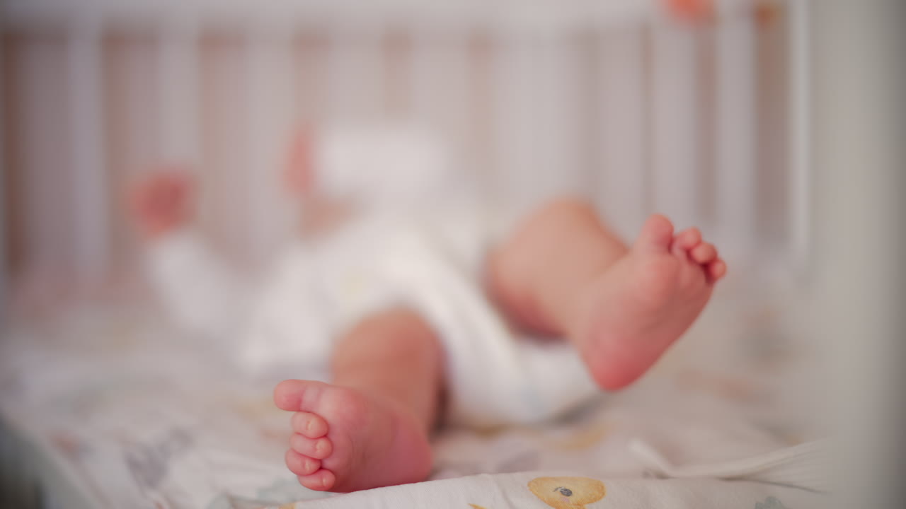 Close up of baby's feet moving around on a bed