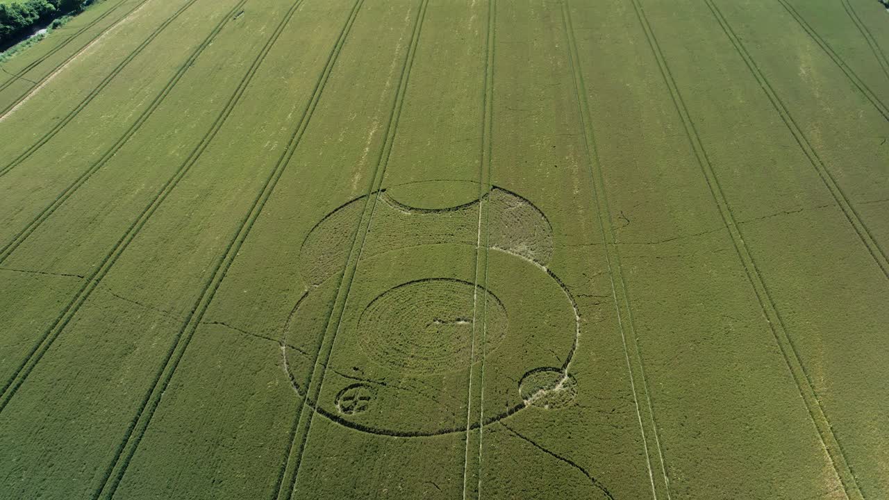 Wiltshire Wootton rivers strange crop circle pattern in countryside farmland field aerial drone view descending tilt up