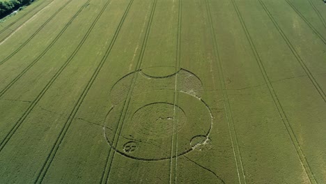 wiltshire wootton rivers strange crop circle pattern in countryside farmland field aerial drone view descending tilt up