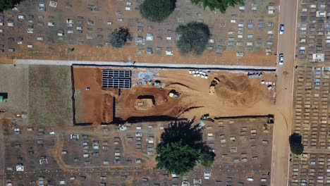 zooming out, process of excavation of mass graves for victims of the covid19 disease, in the cemetery of brasilia, brazil