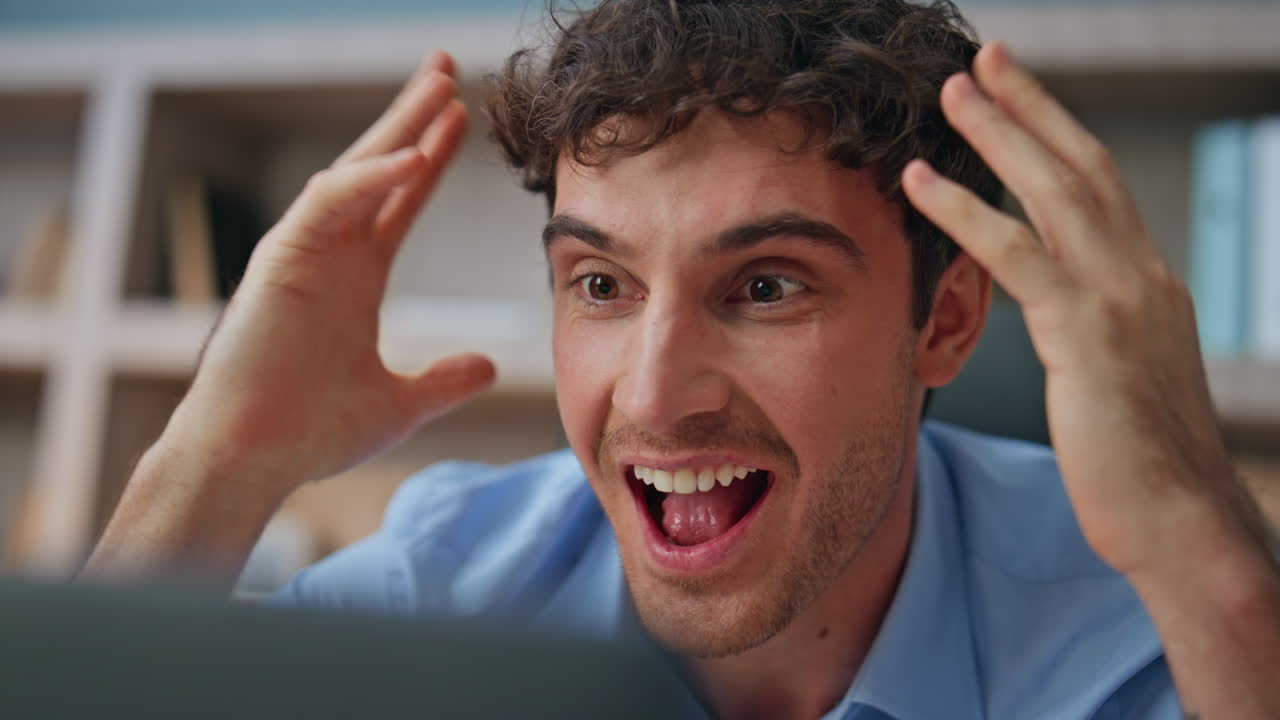 Closeup amazed man face in office. Excited shocked businessman receiving news