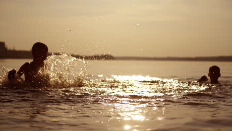 kids playing in the river. children play splash water on the river happily
