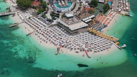 ksamil beach, luxury resort on beach front with sun beds and umbrellas