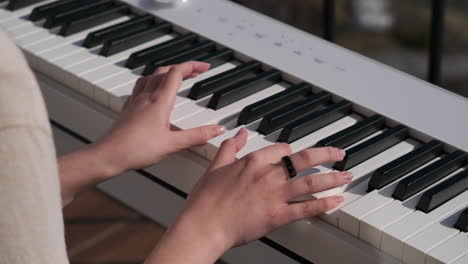 hands playing digital piano outdoors