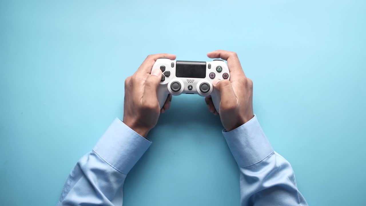 Person Playing Video Game with Playstation Controller