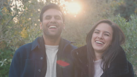 Portrait-Of-Loving-Young-Couple-Meeting-Outdoors-In-Fall-Or-Winter-Countryside-Against-Flaring-Sun