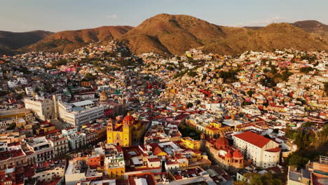 aerial view diving toward the cityscape of guanajuato, golden hour in mexico