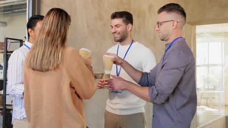 business people drinking takeaway coffee at office