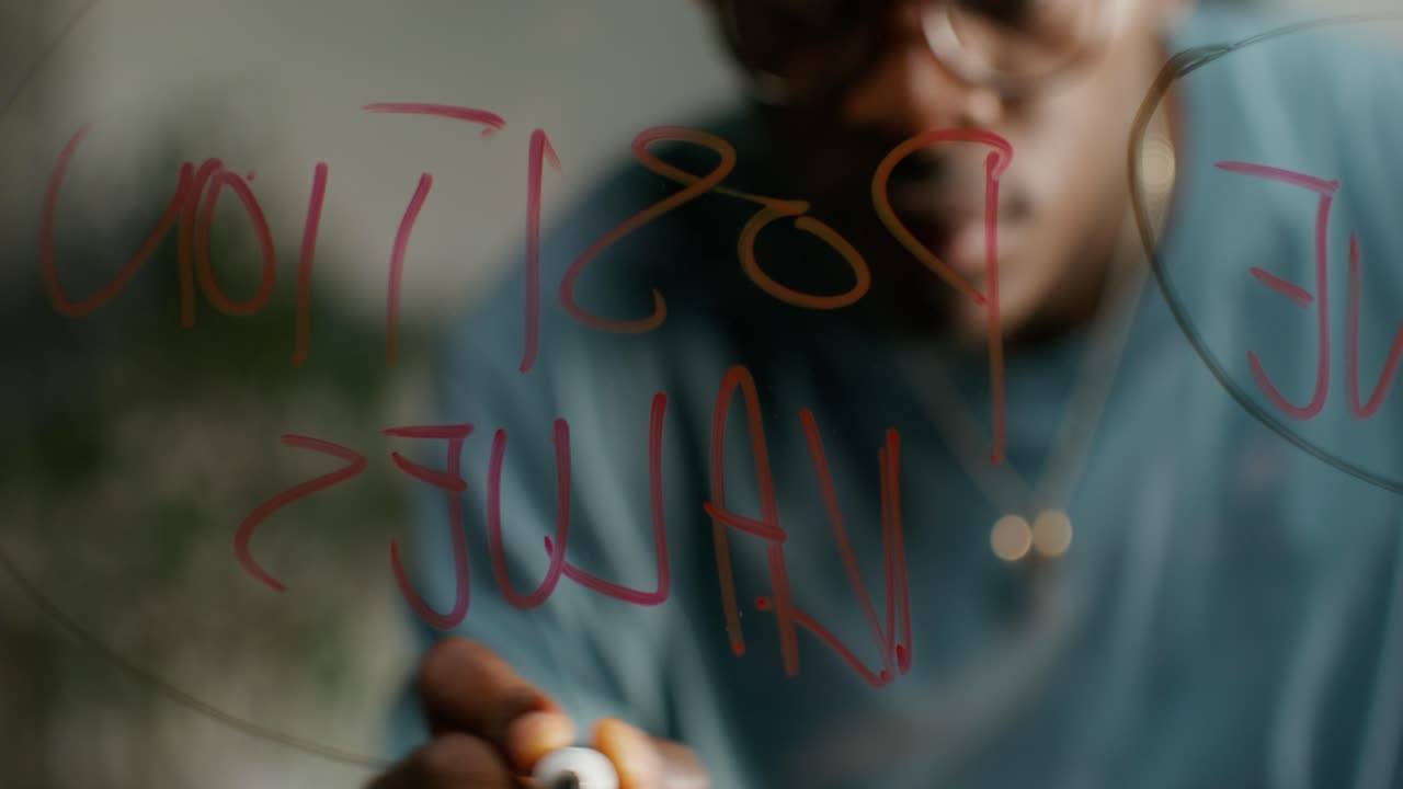 Person Writing Notes on Glass