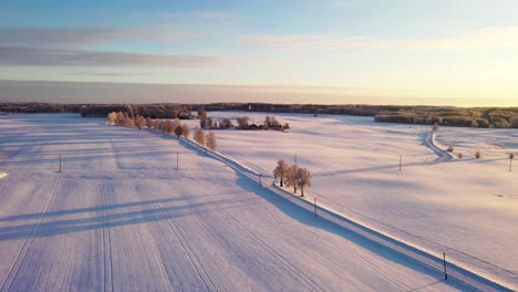 Sunny-Winter-Morning-with-Fresh-Snow-Covered-Fields,-Aerial-Drone-View