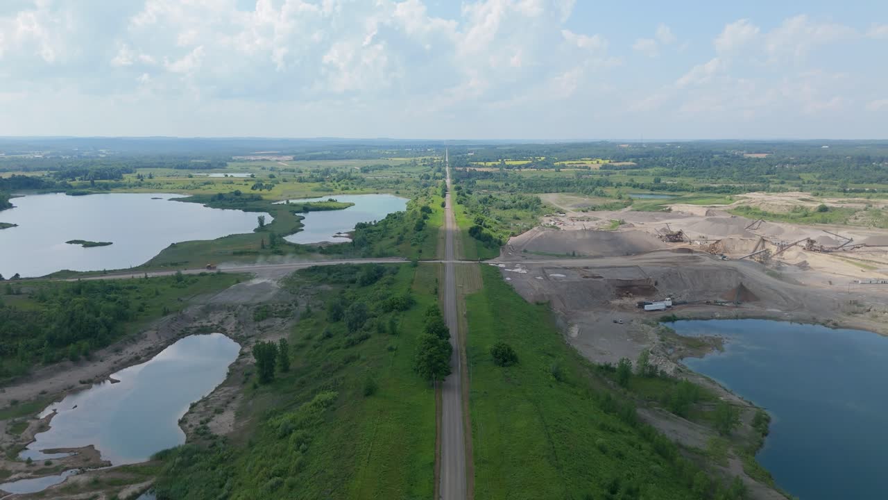 Side Road Surrounded By Gravel Pit Quarry Mining Aggregates In Caledon, Canada. Aerial Flyover