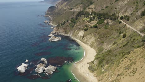 Aerial-View-of-Coastal-Secluded-Beach,-Pan-Up