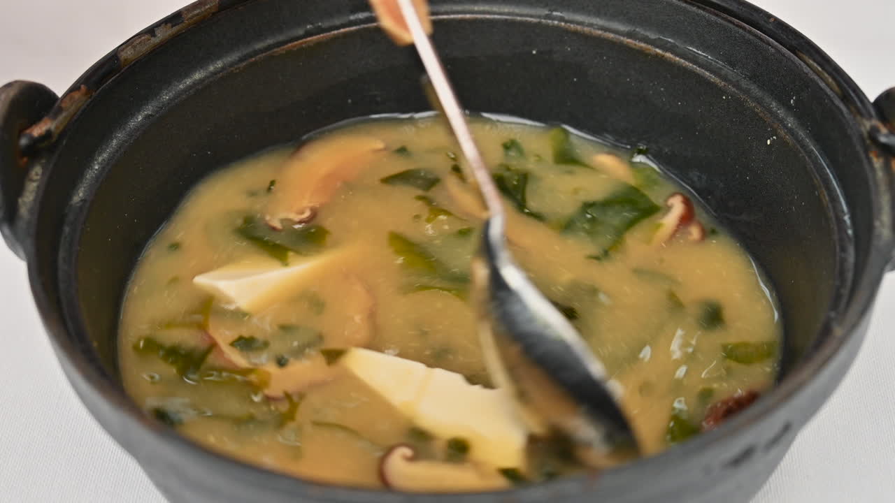 Japanese seaweed miso soup with tofu cheese, slow motion stir