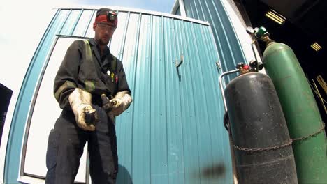 a mechanic lights a oxy-acetylene torch in slow motion