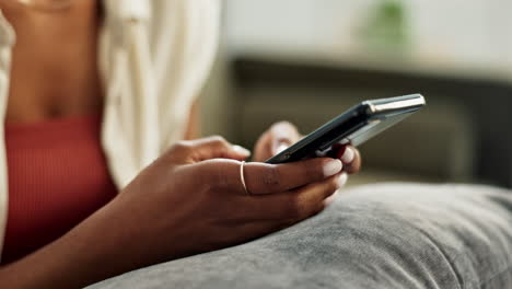 Hands,-woman-and-typing-on-smartphone-in-home