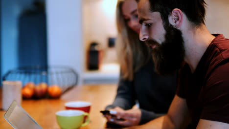 couple using laptop and mobile phone at home 4k