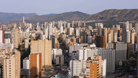 Aerial-panning-view-of-Benidorm-city-skyline-with-skyscraper-building,-travel-destination