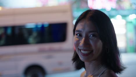 smiling woman at night in a city