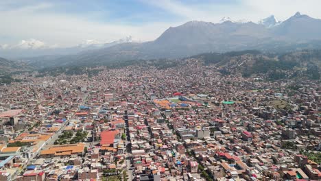Sprawling city of Huaraz, nestled in a valley and surrounded by the majestic snow-capped peaks of the Peruvian Andes - A stunning high-altitude aerial parallax