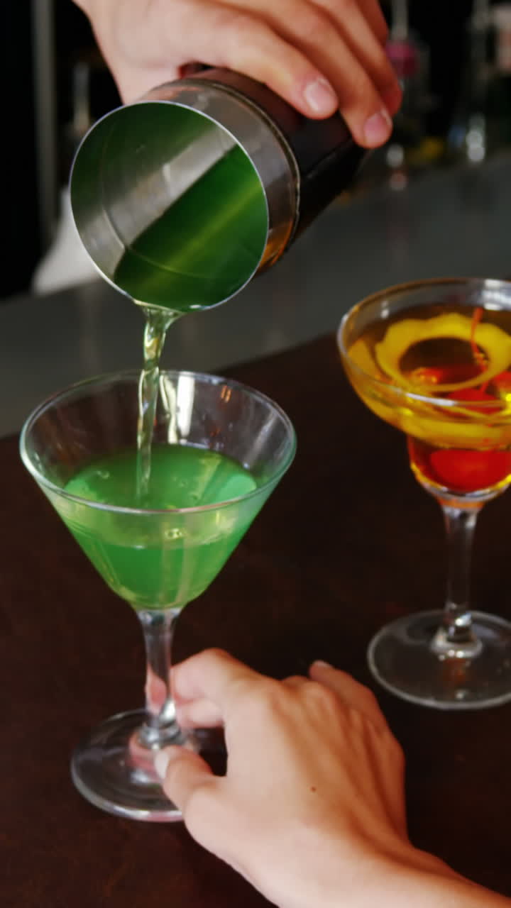 Primo piano di un barman che serve un cocktail a una donna