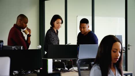 Business-colleagues-discussing-over-computer-4k