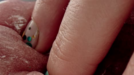 4k close-up of fingers digging in putty slime toy