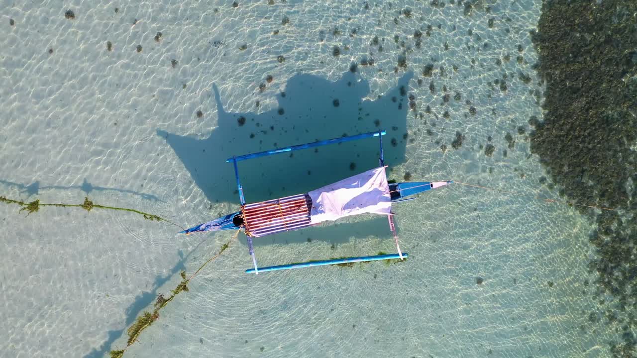 Overhead Shot Of An Outrigger Canoe In Crystal Clear Water. Philippines, Asia