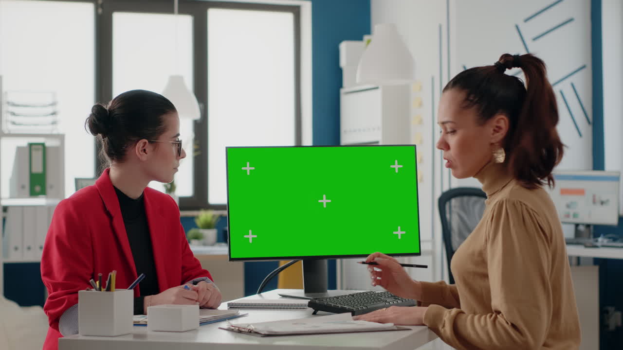 People doing teamwork with green screen on monitor