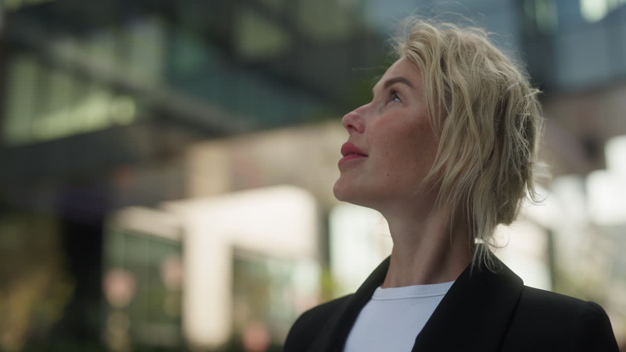 Businesswoman Looking Up in City