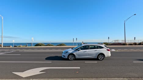 vehicles moving on a sunny day by the beach