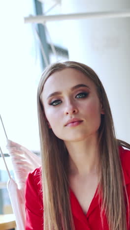 happy beautiful woman in cafe. fashion portrait of style woman resting in cafe. vertical video
