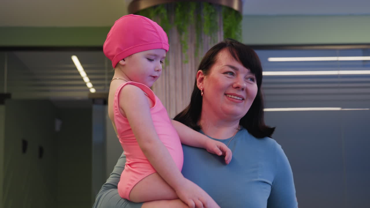 Baby clinging to caregiver while being carried around, small arms wrapped tight, cheek pressed to shoulder, gentle sway, warm daylight, secure hold, soft background blur, calm family moment